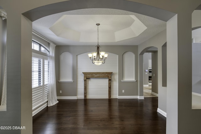 2809 Oakgrove Ave, Saint Augustine, FL 32092 - foyer entrance with wood finished floors, a raised ceiling, a chandelier, and arched walkways