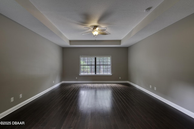 2809 Oakgrove Ave, Saint Augustine, FL 32092 - spare room with a ceiling fan, a raised ceiling, and dark wood-style flooring