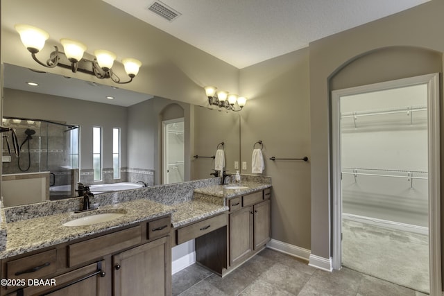 2809 Oakgrove Ave, Saint Augustine, FL 32092 - bathroom with a shower stall, double vanity, a bath, a walk in closet, and tile patterned floors
