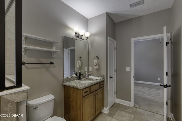 2809 Oakgrove Ave, Saint Augustine, FL 32092 - bathroom featuring vanity, tile patterned flooring, and a textured ceiling