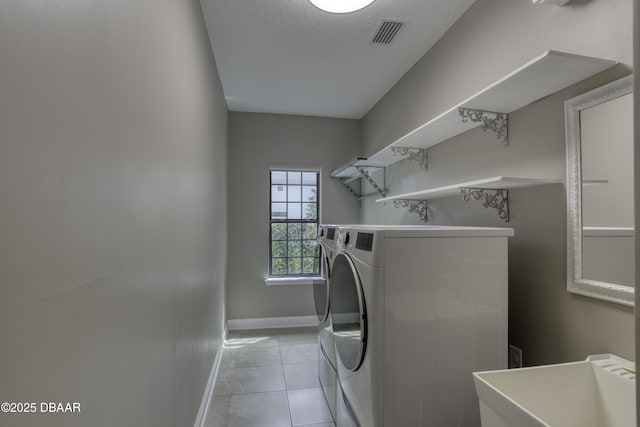 2809 Oakgrove Ave, Saint Augustine, FL 32092 - washroom featuring separate washer and dryer, light tile patterned floors, and a textured ceiling