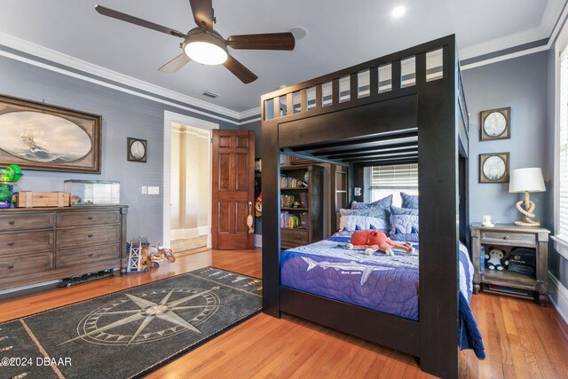 bedroom with ornamental molding, hardwood / wood-style floors, and ceiling fan