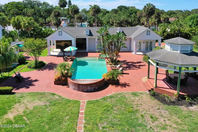 view of pool featuring a lawn, a gazebo, and a patio area