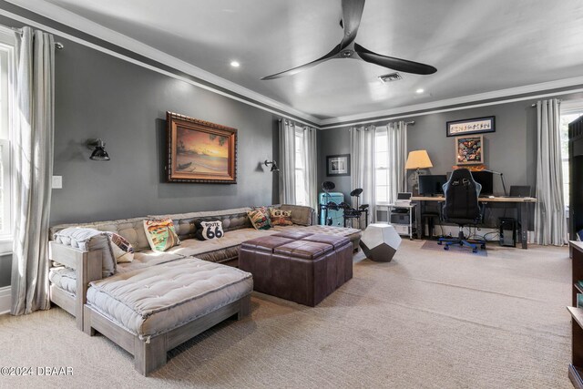 carpeted living room with ceiling fan and ornamental molding