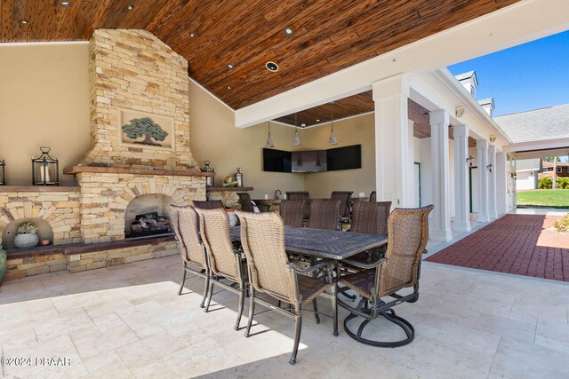 view of patio featuring an outdoor stone fireplace