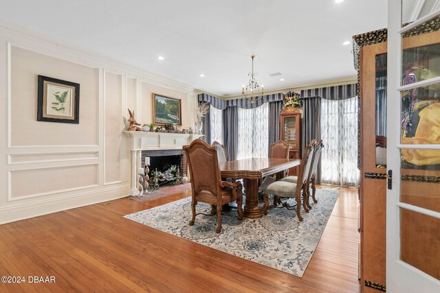 dining room featuring light hardwood / wood-style floors, a chandelier, and ornamental molding