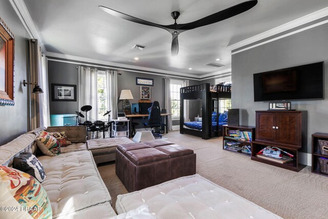 carpeted living room featuring ceiling fan and crown molding