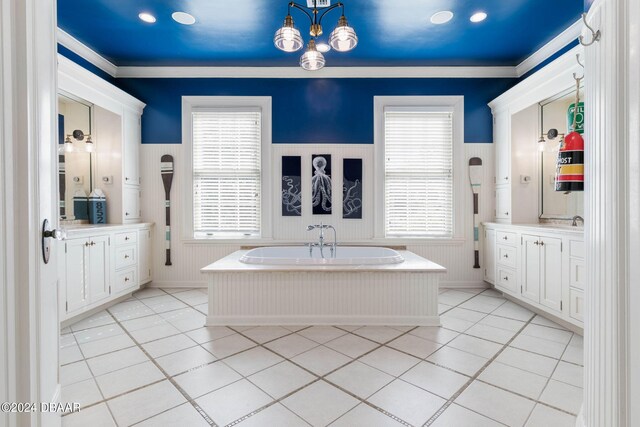 bathroom with a bathtub, plenty of natural light, vanity, and tile patterned floors