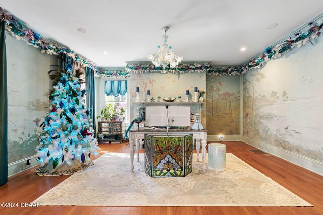 dining space featuring hardwood / wood-style floors and a chandelier