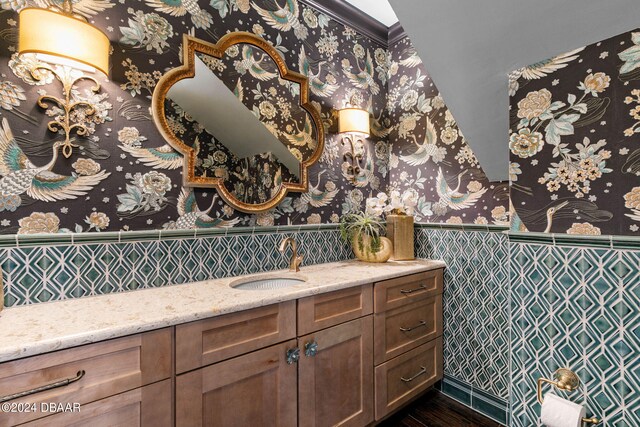 bathroom featuring tile walls and vanity