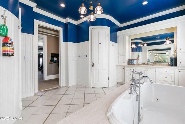 bathroom with a tub to relax in, vanity, tile patterned flooring, and ornamental molding