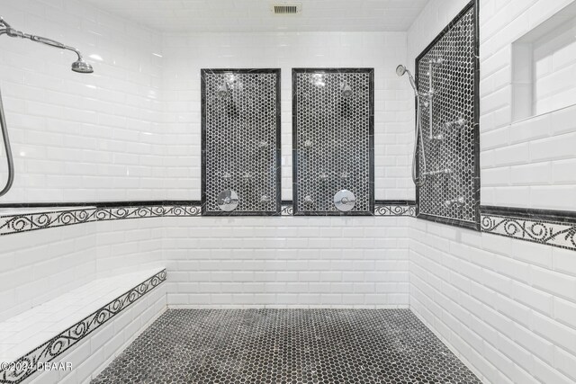 bathroom with tiled shower