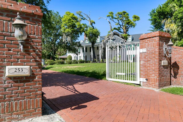 view of gate with a yard