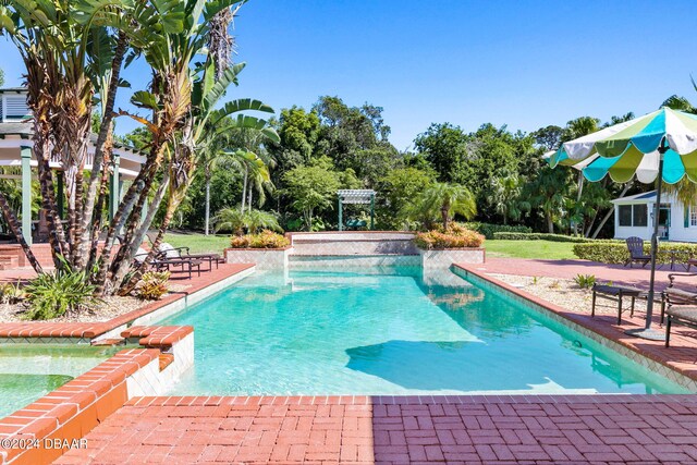 view of pool featuring pool water feature and a patio area