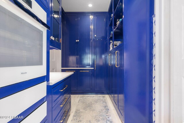 walk in closet featuring light hardwood / wood-style flooring