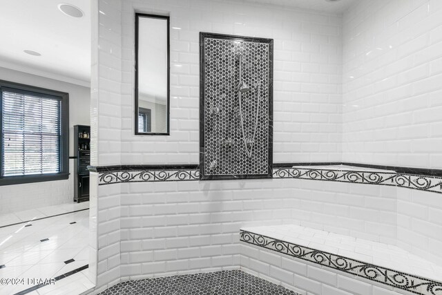 bathroom featuring tile walls and crown molding