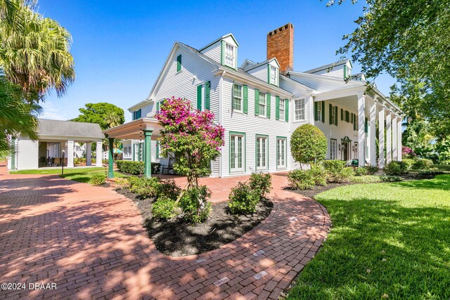 rear view of property featuring a yard