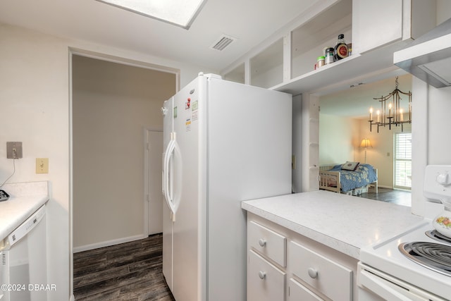 kitchen featuring island range hood, white cabinetry, dark hardwood / wood-style flooring, hanging light fixtures, and white appliances