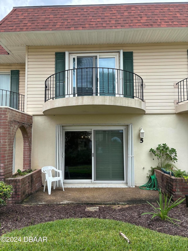 back of house featuring a balcony