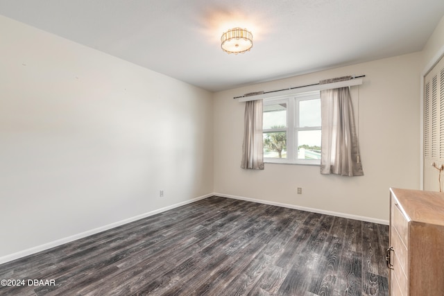 unfurnished room featuring dark hardwood / wood-style flooring