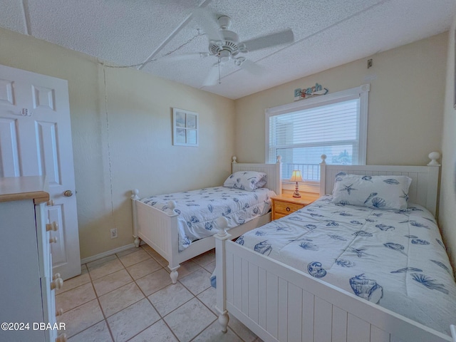 2700 Ocean Shore Blvd Unit 313, Ormond Beach, FL 32176 - bedroom featuring light tile patterned flooring, a ceiling fan, and a textured ceiling