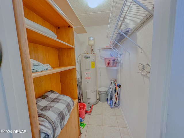 interior space featuring electric water heater and tile patterned flooring