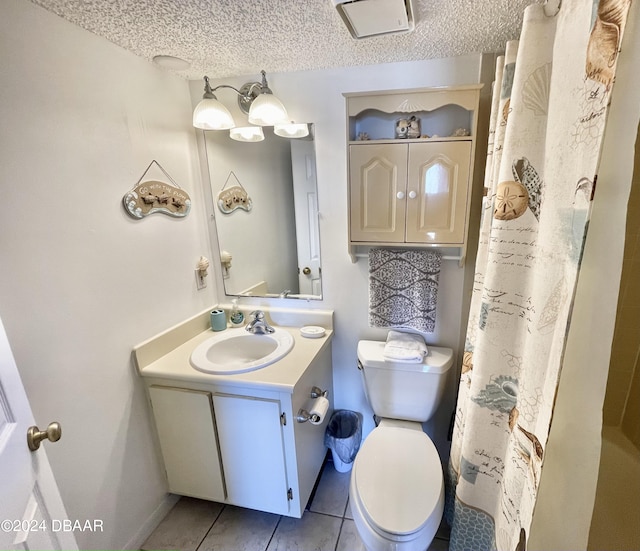 bathroom featuring tile patterned flooring, a shower with curtain, a textured ceiling, vanity, and toilet