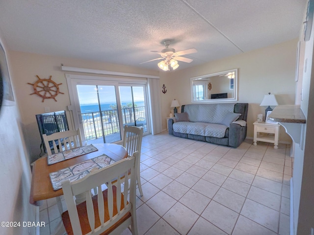2700 Ocean Shore Blvd Unit 313, Ormond Beach, FL 32176 - dining room featuring light tile patterned floors, a ceiling fan, and a textured ceiling