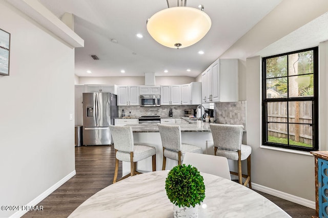 dining space featuring sink and dark hardwood / wood-style floors