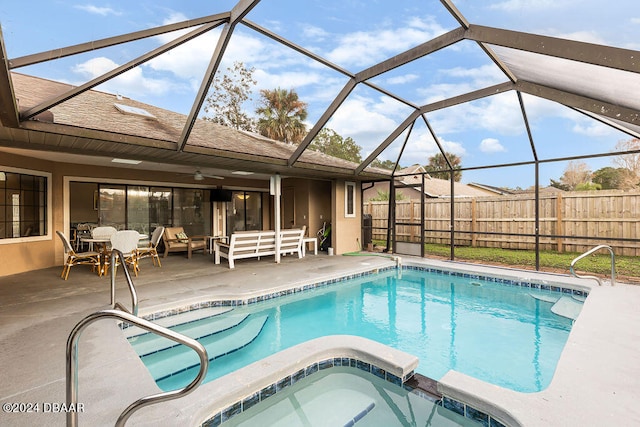 view of swimming pool with an in ground hot tub, ceiling fan, a patio, a lanai, and outdoor lounge area