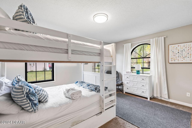 carpeted bedroom with a textured ceiling