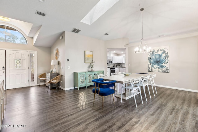 dining space featuring dark wood-type flooring, lofted ceiling with skylight, and a notable chandelier