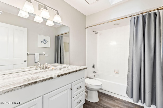 full bathroom with vanity, hardwood / wood-style flooring, toilet, and shower / bathtub combination with curtain