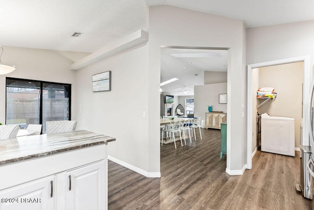 kitchen with white cabinetry, lofted ceiling, hardwood / wood-style flooring, and a healthy amount of sunlight