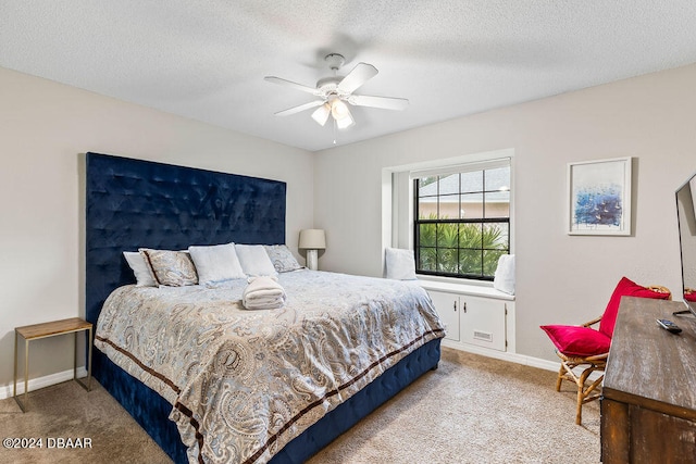 carpeted bedroom featuring a textured ceiling and ceiling fan