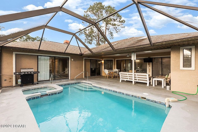 view of pool with a patio, a lanai, a grill, and an in ground hot tub