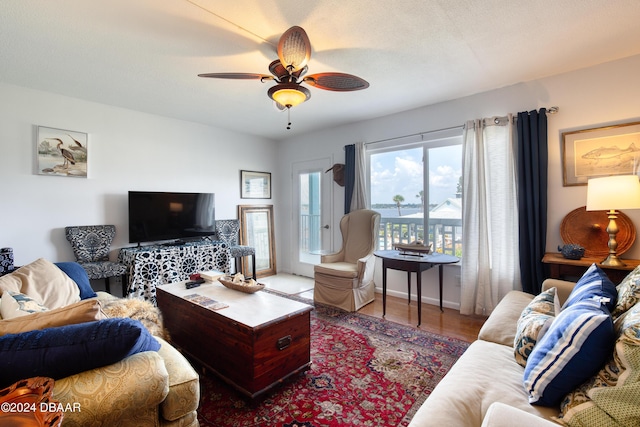 living room featuring hardwood / wood-style floors, a textured ceiling, and ceiling fan