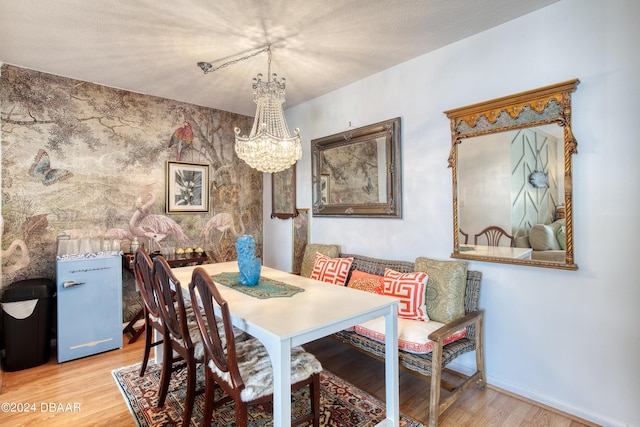 dining room with hardwood / wood-style floors and a chandelier