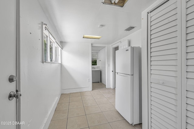 1214 Flomich St, Daytona Beach, FL 32117 - kitchen featuring freestanding refrigerator and light tile patterned floors