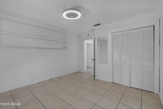 1214 Flomich St, Daytona Beach, FL 32117 - unfurnished bedroom featuring light tile patterned flooring and a closet