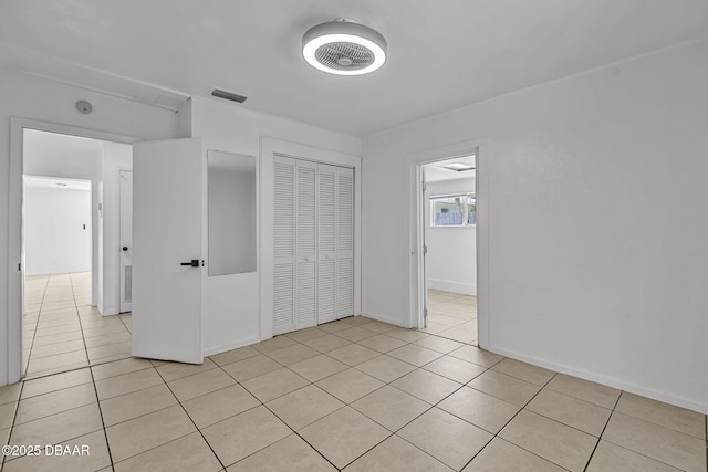 1214 Flomich St, Daytona Beach, FL 32117 - unfurnished bedroom with light tile patterned flooring and a closet