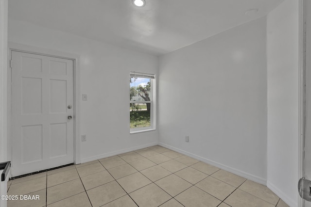 1214 Flomich St, Daytona Beach, FL 32117 - empty room featuring light tile patterned flooring and baseboards