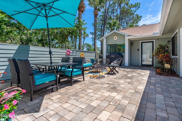 view of patio / terrace with outdoor dining area and fence