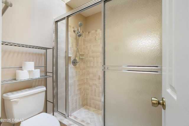 full bath featuring toilet and a stall shower