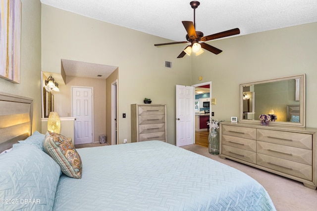 bedroom featuring a textured ceiling, high vaulted ceiling, visible vents, ceiling fan, and carpet flooring