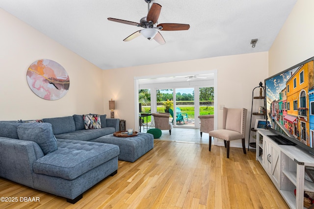 living room featuring light wood-type flooring and a ceiling fan