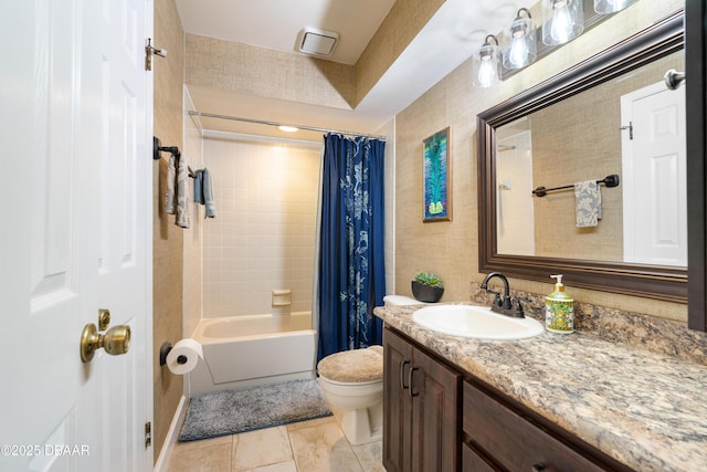 full bath with vanity, toilet, tile patterned flooring, and shower / bath combo