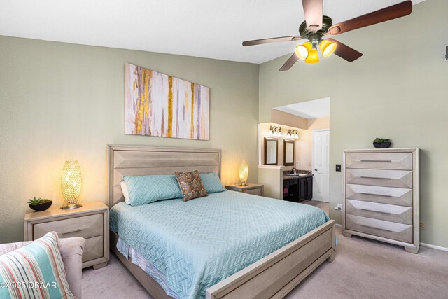bedroom with carpet flooring, ensuite bathroom, baseboards, visible vents, and lofted ceiling