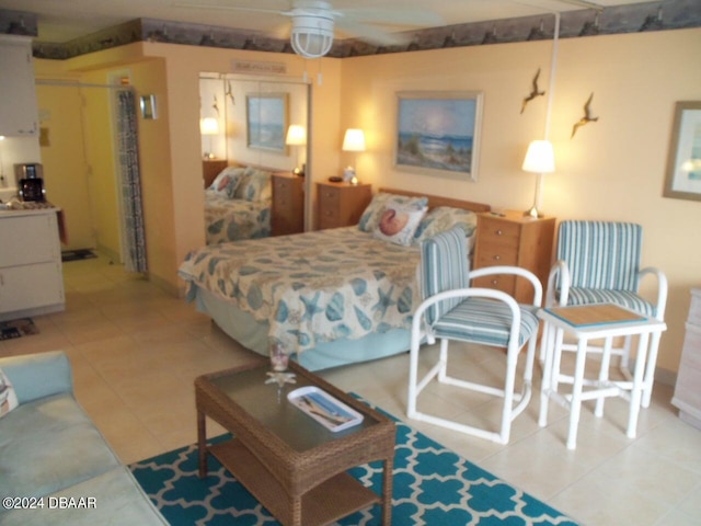 tiled bedroom featuring ceiling fan