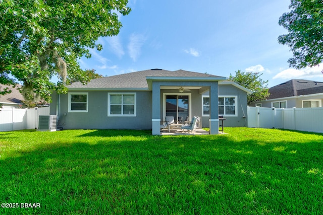 back of house featuring central air condition unit, a patio area, ceiling fan, and a yard